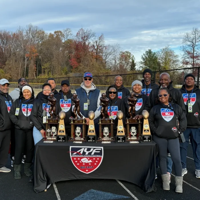 CBL board members behind a table of AYF Big East championship trophies