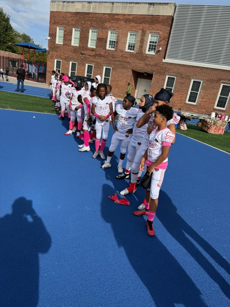CBL team lined up in pink accessories before a game