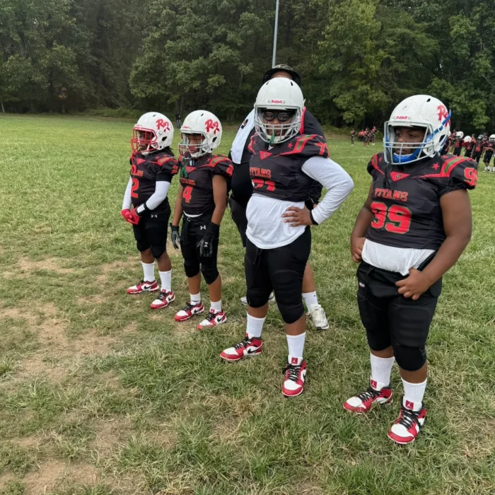 Titans players in black and red uniforms on the practice field